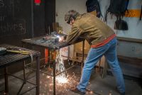 Welding student in a class at The Crucible